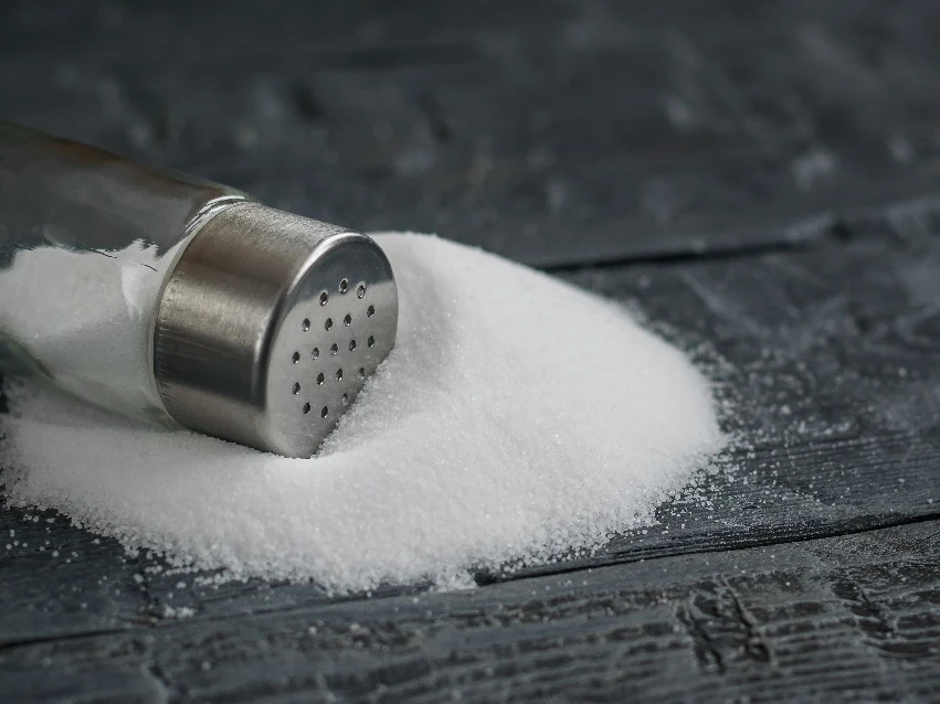 Table salt pile with a glass shaker